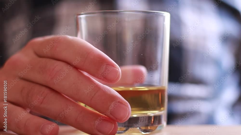 Holding and drinking whiskey closeup Holding and drinking whiskey closeup