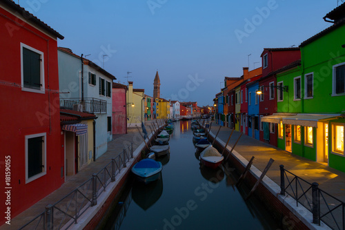 Colorful houses and boats at night in Burano, Venice Italy. © Shchipkova Elena