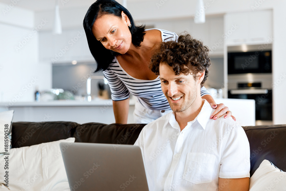 Couple at home using laptop Couple at home using laptop