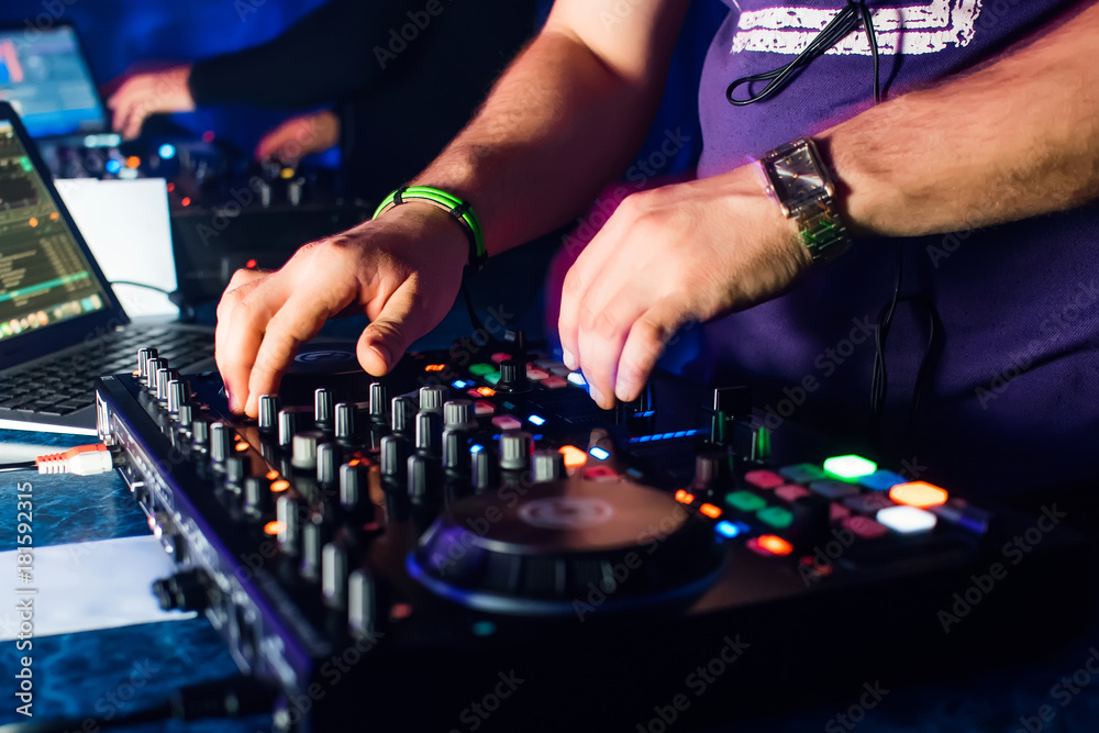 hands of DJs playing on professional Board and mixer with laptop hands of DJs playing on professional Board and mixer with laptop