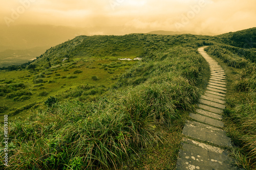 Fantasy-like landscape and path of stepping stones over a grassy bald on Taiwan's mountainous east coast