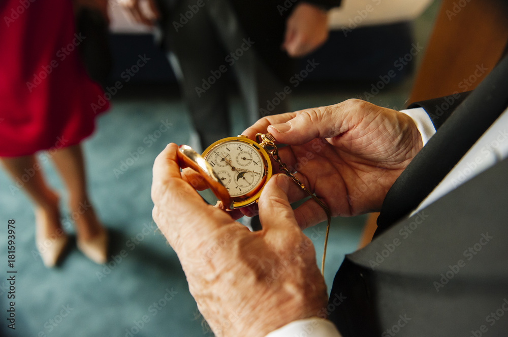 Crop senior man checking time