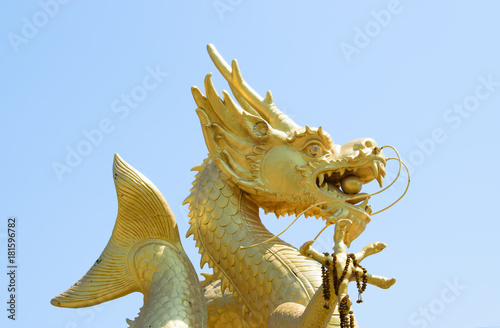 Chinese dragon statue in the mouth with glass balls On the blue sky background