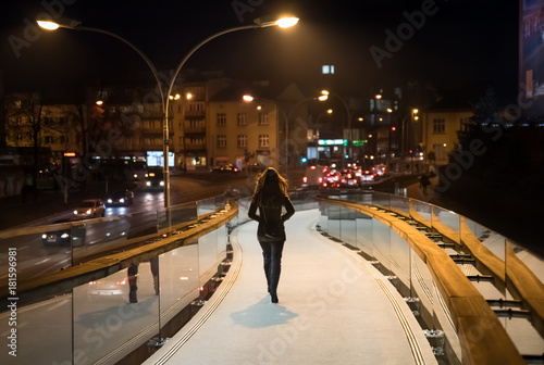 woman going late night on the pedestrian bridge