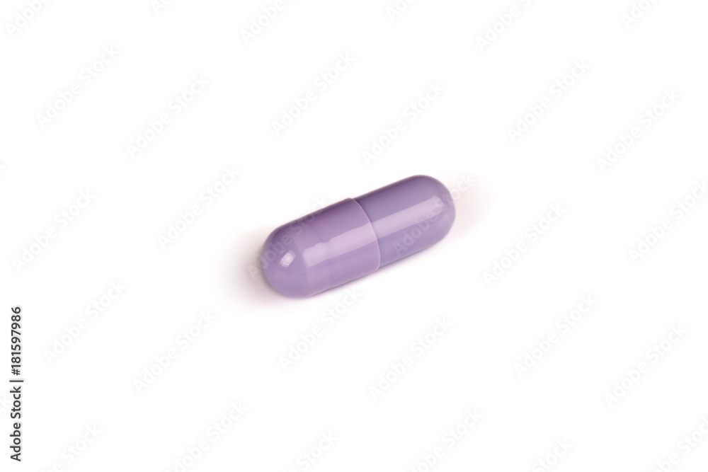 close-up of a purple pill isolated on a white backgound.psd
