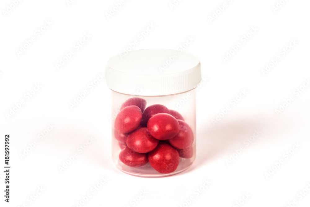 some red pills in a tranxlucent box on a white background some red pills in a tranxlucent box on a white background