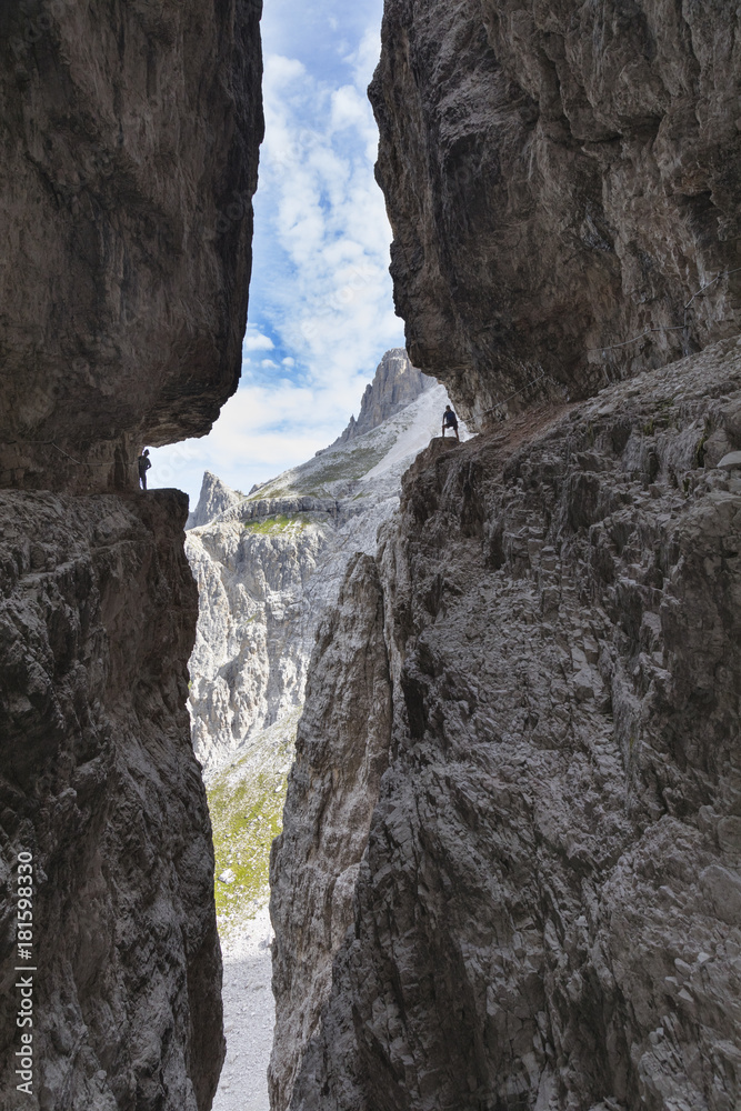 Italy, South Tyrol, Sexten, Hochpustertal, Bolzano. Hiker in silhouette on the Alpinisteig or Strada degli Alpini via ferrata, Sexten Dolomites Italy, South Tyrol, Sexten, Hochpustertal, Bolzano. Hiker in silhouette on the Alpinisteig or Strada degli Alpini via ferrata, Sexten Dolomites