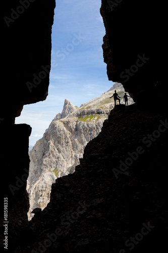 Italy, South Tyrol, Sexten, Hochpustertal, Bolzano. Hiker in silhouette on the Alpinisteig or Strada degli Alpini via ferrata, Sexten Dolomites photo