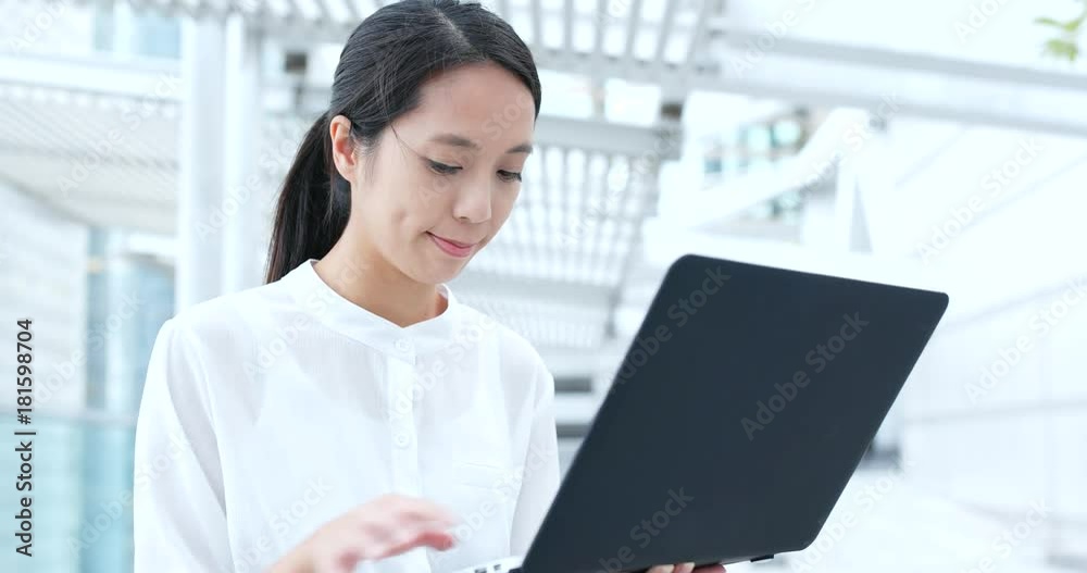 Business woman use of notebook computer in city Business woman use of notebook computer in city