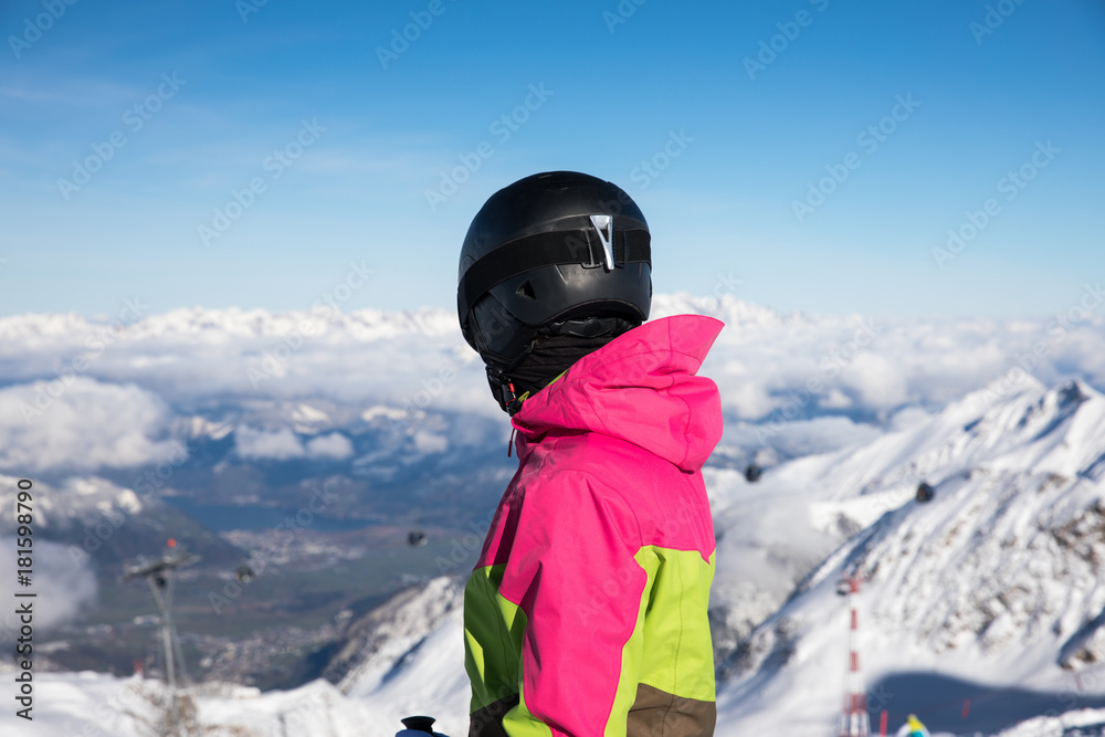 Young, sexy woman is skiing in winter paradise in the alps with a beautiful blue sky and wonderful white snowy mountains 