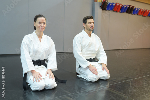 the karate girl and boy with black belts