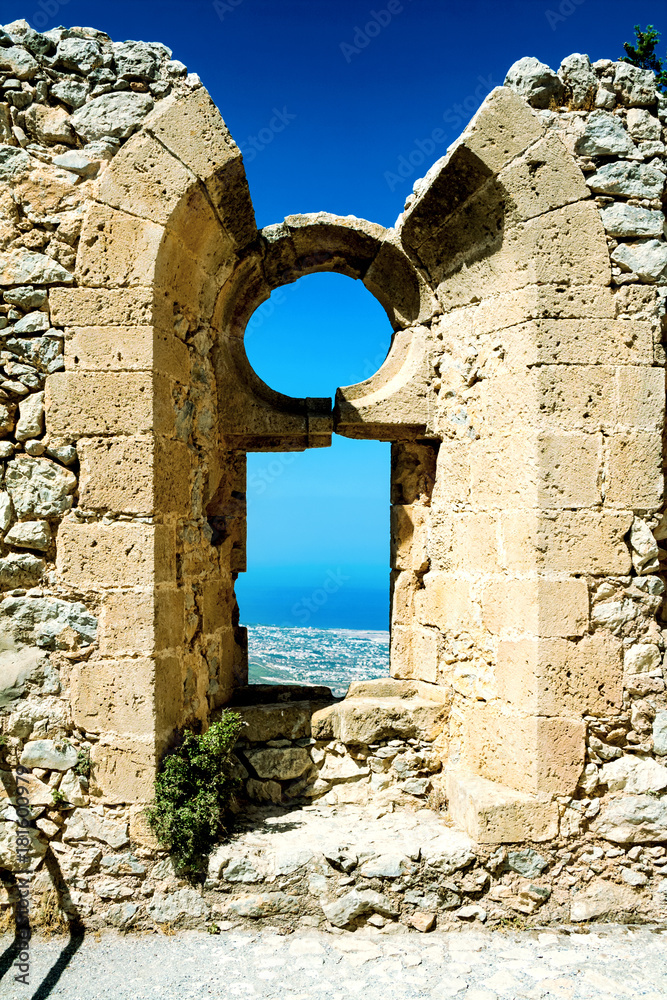 View of a mountain valley and sky and a coastline from the window of the castle of St. Hilarion, Northern Cyprus, St. Hilarion's Castle, Turkey