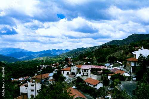 The landscape offers a view of the mountains, the forest and a small village with red roofs. Cyprus, Troodos © Natallia