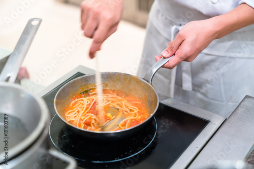 chef cooking spaghetti