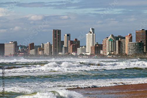 Rough sea against blue cloudy city skyline in  Durban