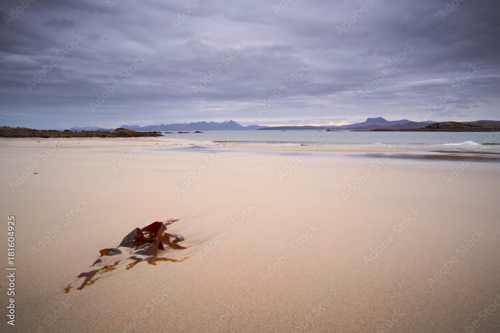Obraz premium Sandy beach at Mellon Udrigle looking out over Gruinard Bay and the mountains around Ullapool. North West Highlands of Scotland.