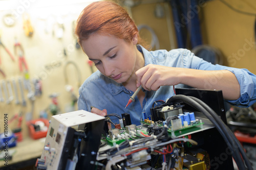 pretty woman repairing electronic chip