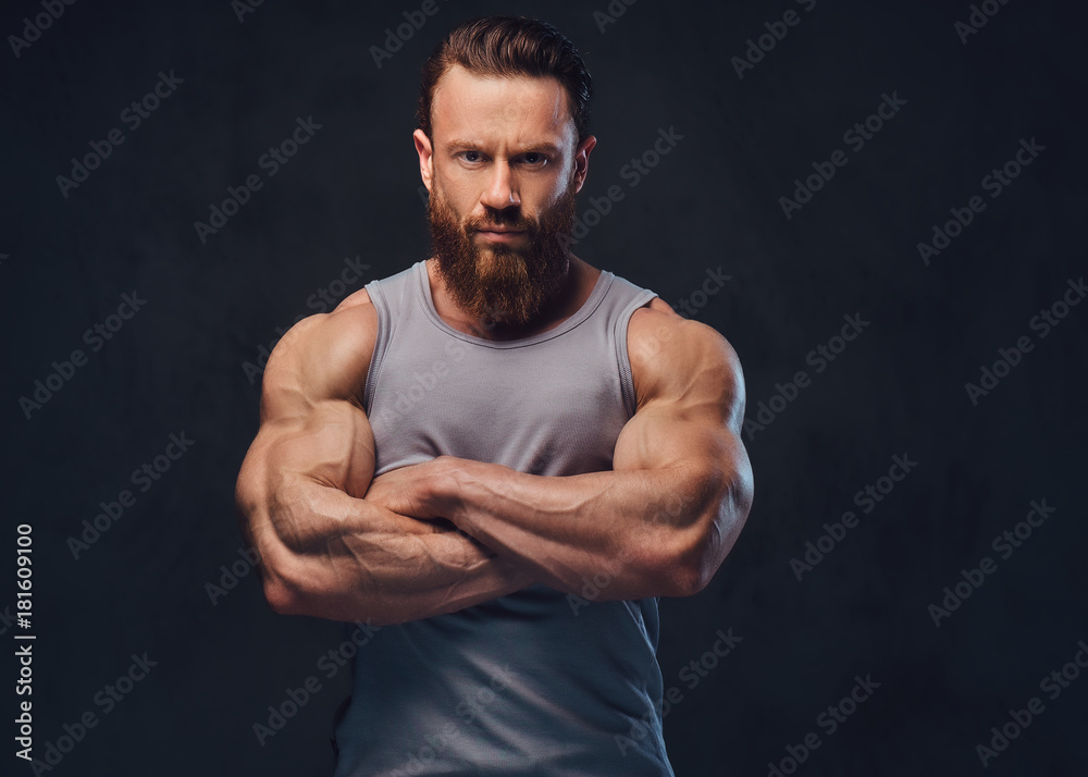 Bearded bodybuilder dressed in a tank top. Bearded bodybuilder dressed in a tank top.