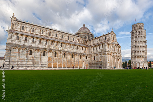 Tourists visiting the Renaissance square of "Miracles" with the famous leaning tower, in the city of Pisa.