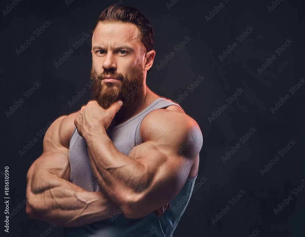 Bearded bodybuilder dressed in a tank top. Bearded bodybuilder dressed in a tank top.