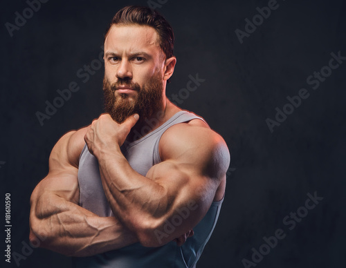 Bearded bodybuilder dressed in a tank top. © Fxquadro