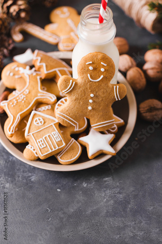 Milk and cookies. Gingerbread  cookies on a gray background.  Christmas cookies.  Ginger men