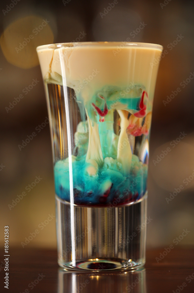 Colourful cocktail shot with multiple liquors mixing Colourful cocktail shot with multiple liquors mixing