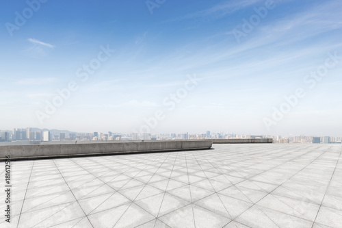 empty brick floor with modern cityscape in foggy day