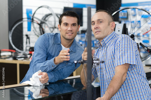 salesman and worker in bicycle shop