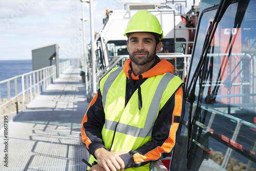 Tableau sur toile Smiling dock worker in hardhat, portrait