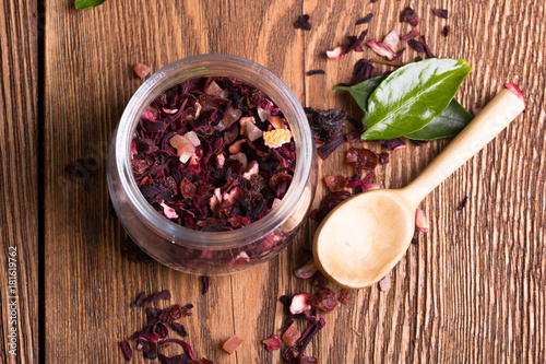 Fototapeta Naklejka Na Ścianę i Meble -  Herbal aroma fruit tea dry leaves on spoon on wooden background