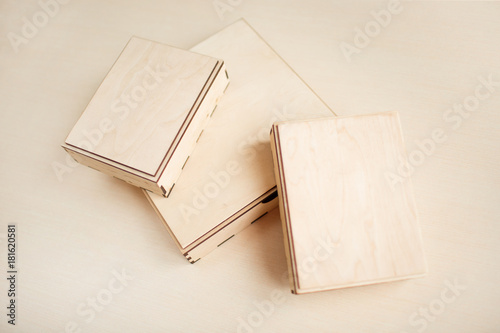 Raw wooden box for small items on wooden background. Different views.