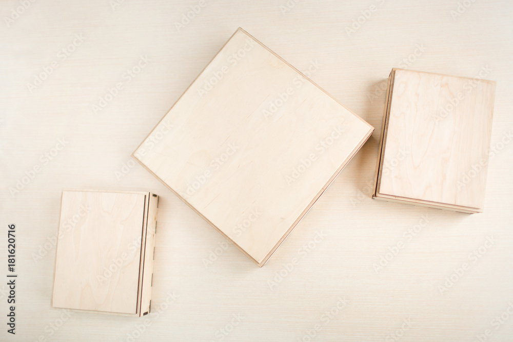 Raw wooden box for small items on wooden background. Different views. Raw wooden box for small items on wooden background. Different views.