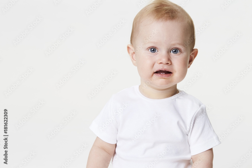 Blue eyed baby boy in white studio, portrait