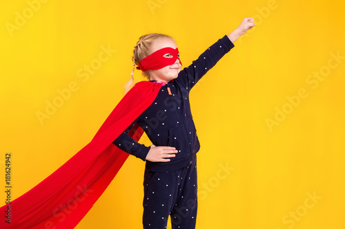 Canvas-taulu Superhero little girl in a red raincoat and a mask