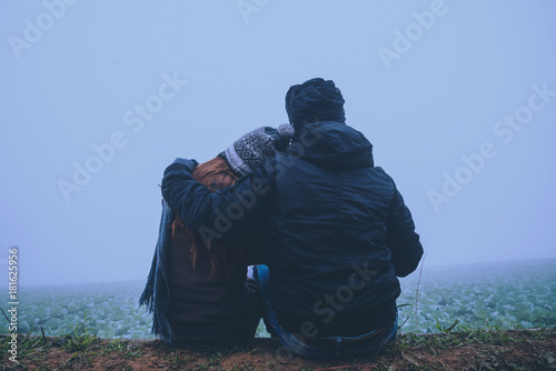 Lover women and men asians travel relax in the holiday. Happy to travel in the holiday. Lovers walk hand in hand on rice field. During the foggy winter