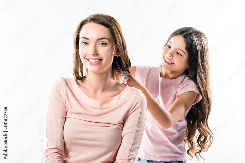 Daughter combing mothers hair