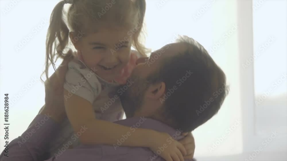 Little Daughter Rushes Into father Arms At Home. Slow motion. Big Hug. Family values. Kiss. Little Daughter Rushes Into father Arms At Home. Slow motion. Big Hug. Family values. Kiss.