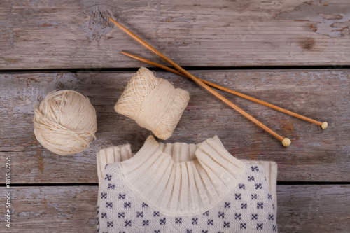 Pullover, skeins and wooden needles