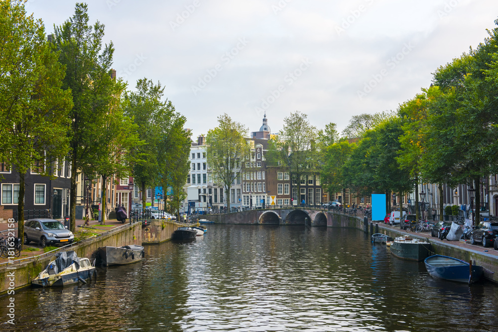 Amsterdam City Center. Beautiful view of Amsterdam Canals with Bridge and typical Dutch Houses. Amsterdam, Netherlands.