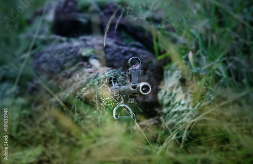 Sniper in the grass with rifle