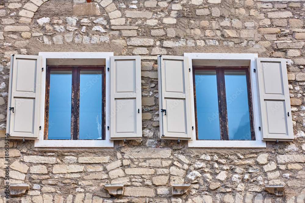 Old wooden window shutters of an mediterranean house,Italian Window with Open Wooden Shutters