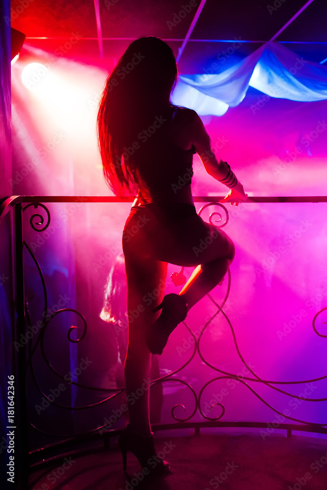 young girl with a sexy slender body dancing on stage dance floor night club  with colored background Stock Photo | Adobe Stock
