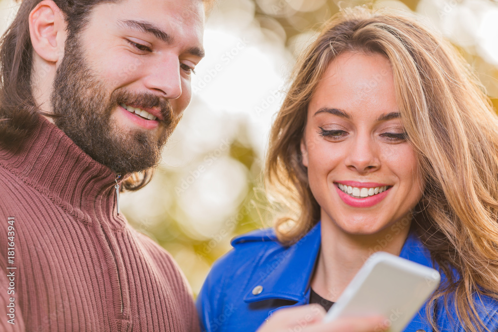Cute couple making selfie in the park at autumn / fall season. Cute couple making selfie in the park at autumn / fall season.
