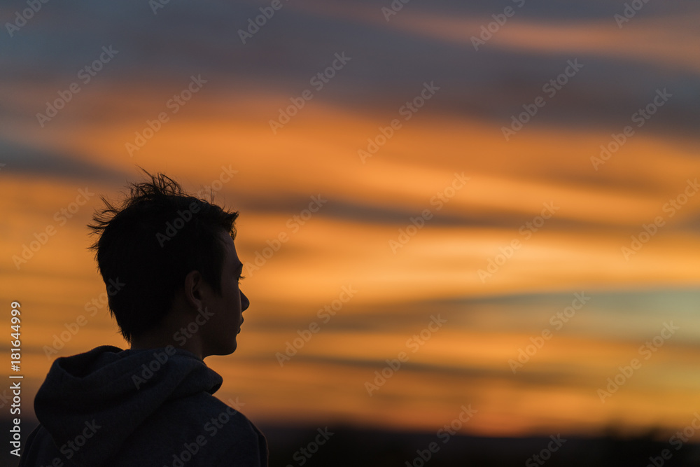 portrait with an Asian young man at sunset