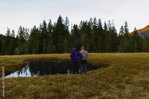 a couple of tourists on the edge of a lake © czamfir