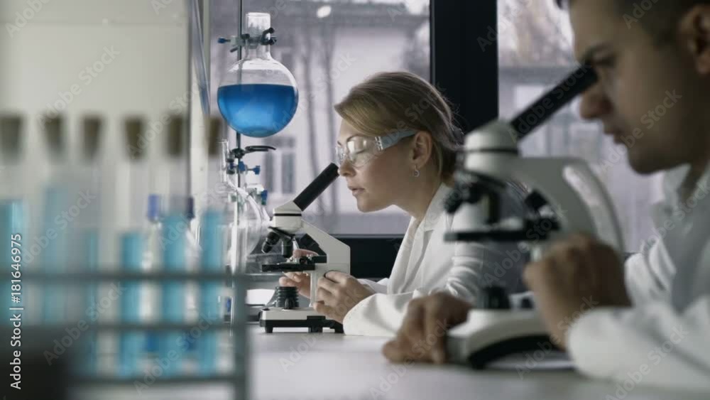 Female researcher conducting an experiment in lab
