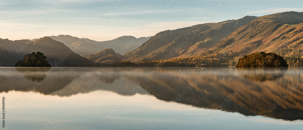 Calm reflections in a still Derwentwater on an Autumnal morning in the Lake District.