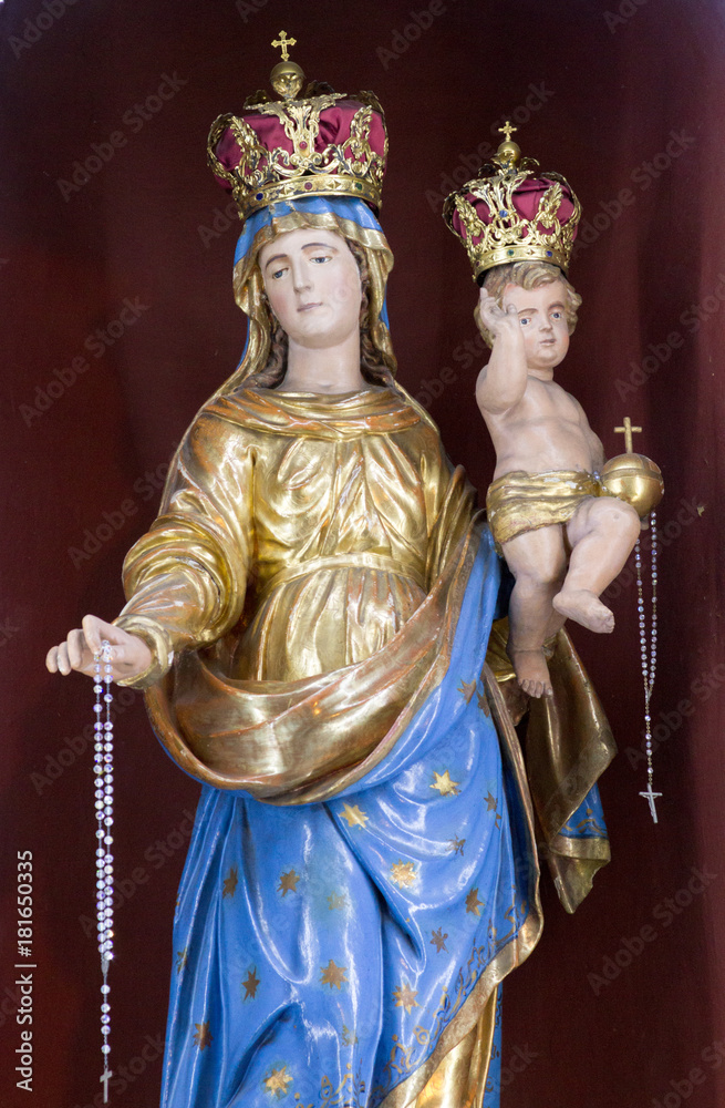 Casorate Primo, Italy. October 26 2017. Statue of Virgin Mary the Queen holding baby Jesus Christ. San Vittore Martire Church (Church of Saint Victor Maurus - the Moor -  the martyr - church)