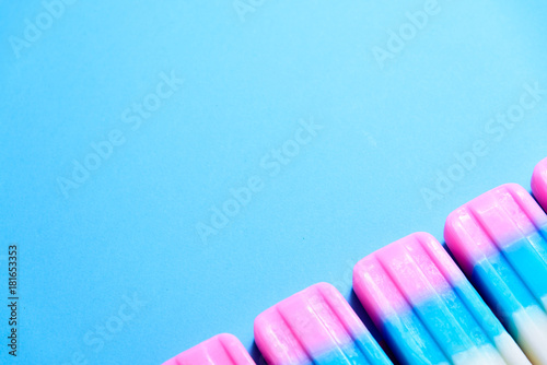 Fruit Ice cream stick   popsicle   ice pop or freezer pop with copyspace on blue pastel background or texture
